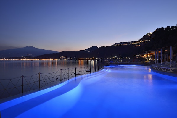 Seasonal outdoor pool, open 8:00 AM to 7:00 PM, pool umbrellas