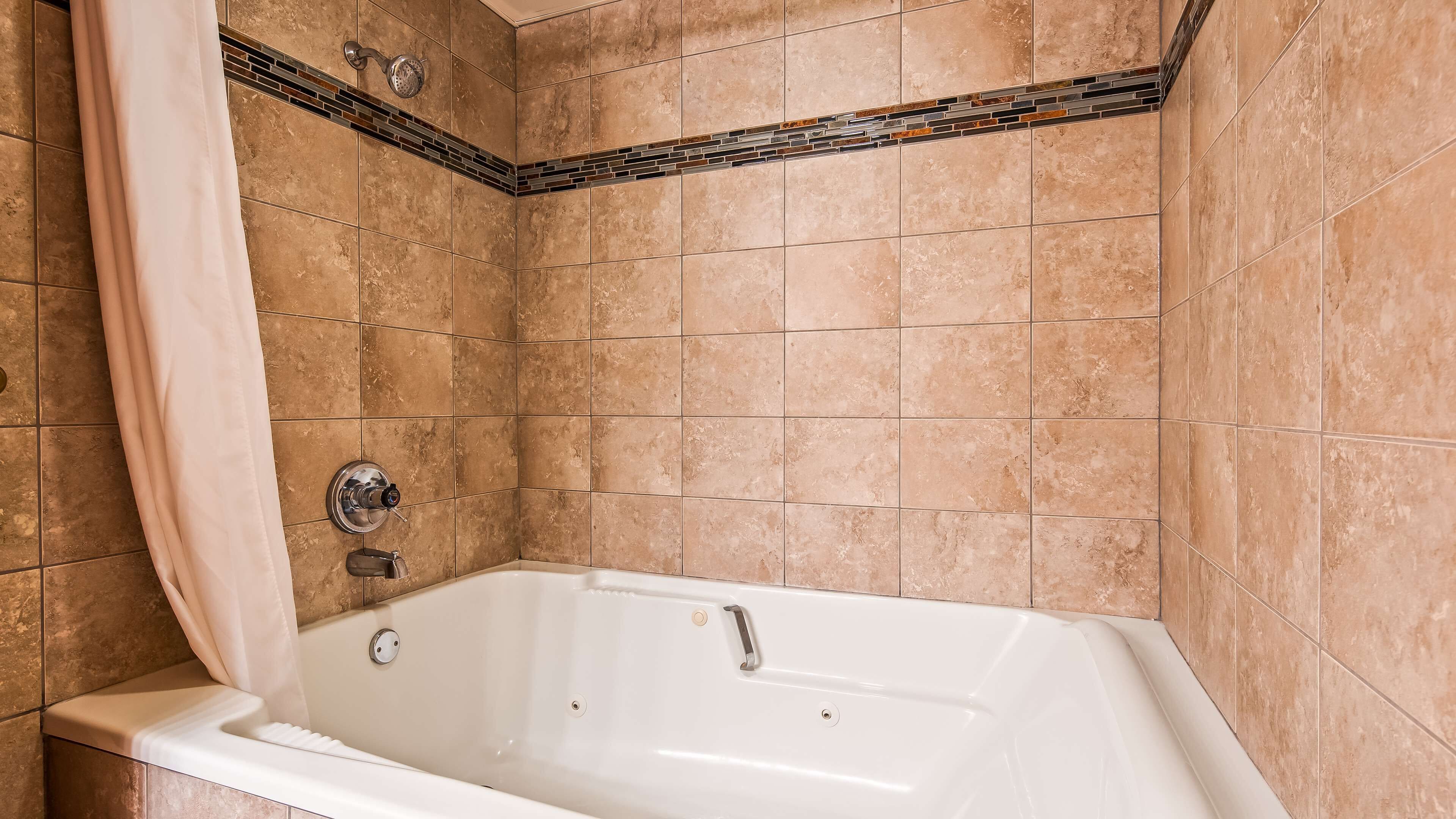 suite, 1 king bed, non smoking, jetted tub (with sofabed) | bathroom | combined shower/bathtub, free toiletries, hair dryer, towels