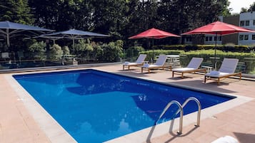 Seasonal outdoor pool, open 9:00 AM to 9:00 PM, pool loungers