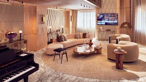 Un salon spacieux avec un grand piano, un canapé d’angle et une table basse.