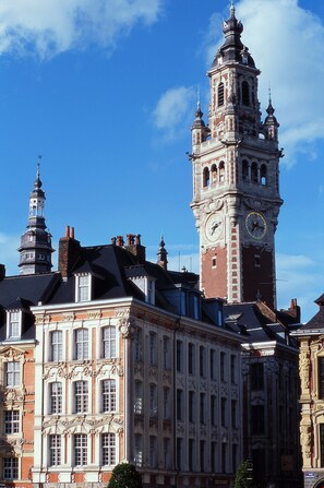 A historic building with a prominent clock tower and ornate architectural details. - Hotel ibis Lille Centre Gares (Lille)