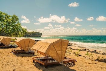 On the beach, white sand, beach towels at Grand Hyatt Kauai Resort and Spa