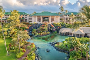 A resort with a central water feature, lush landscaping, and a building with a green roof. - Grand Hyatt Kauai Resort and Spa (Koloa)