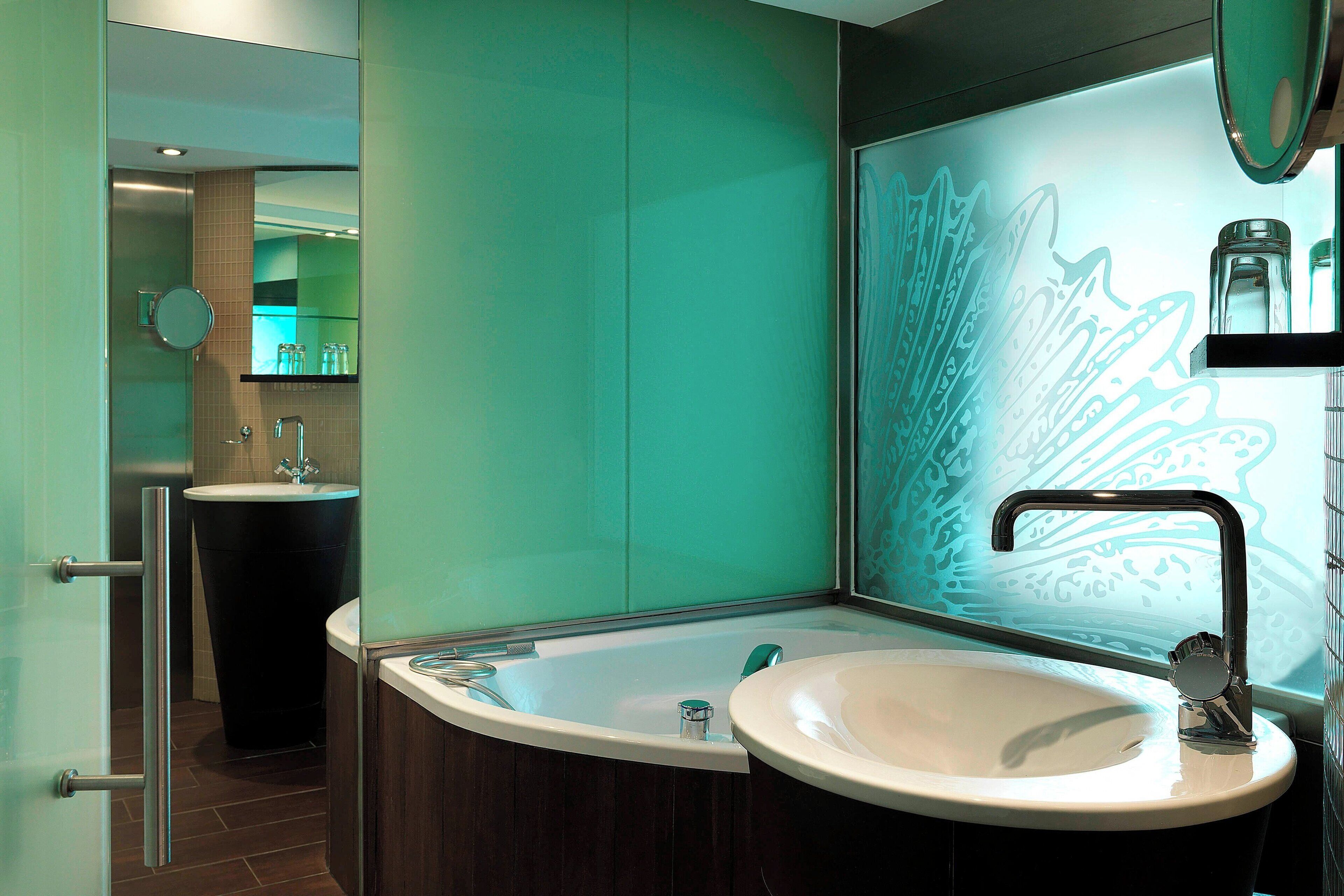 A modern bathroom with a freestanding bathtub, a sink, and a large mirror.