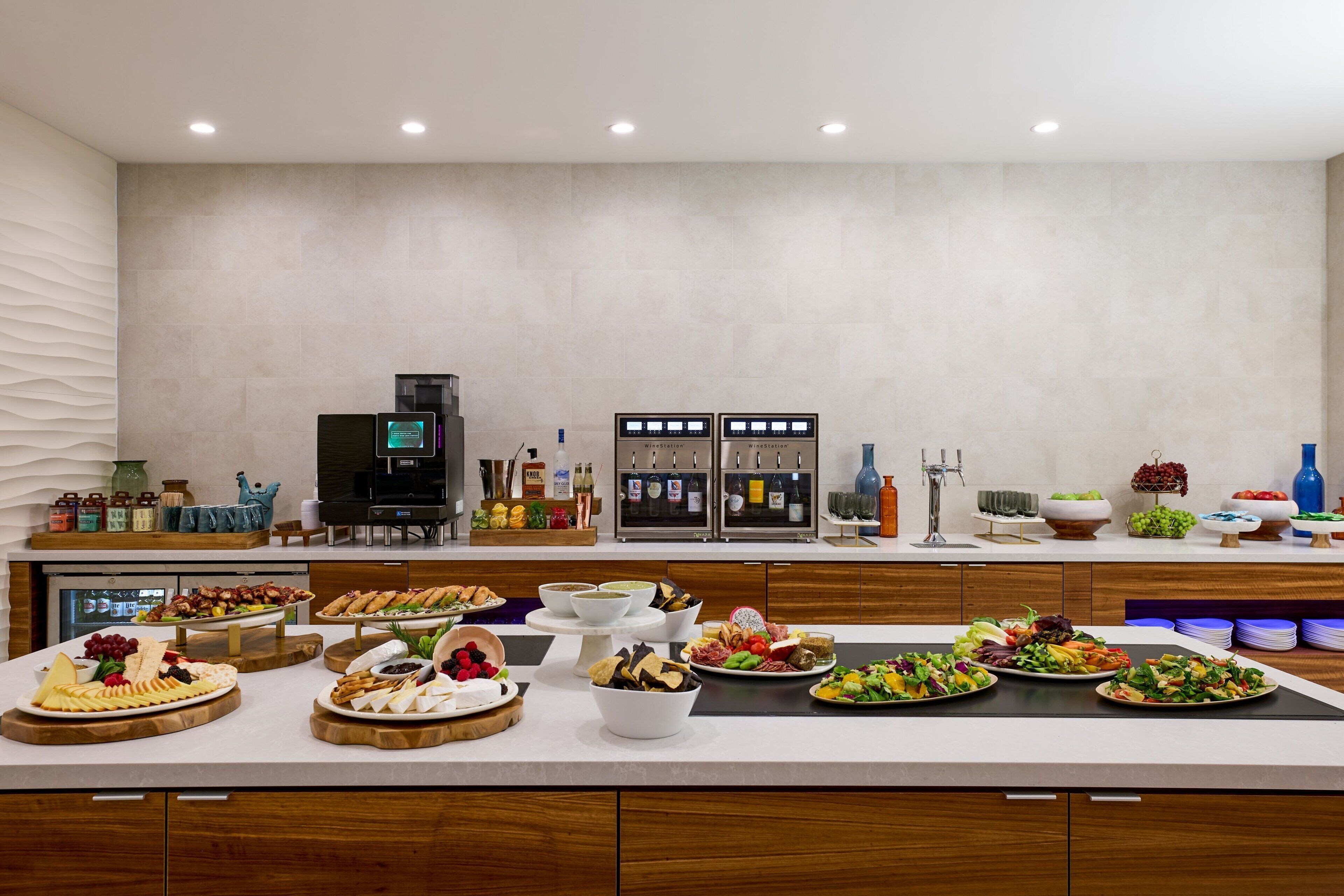 A buffet setup with various food items and a coffee station.