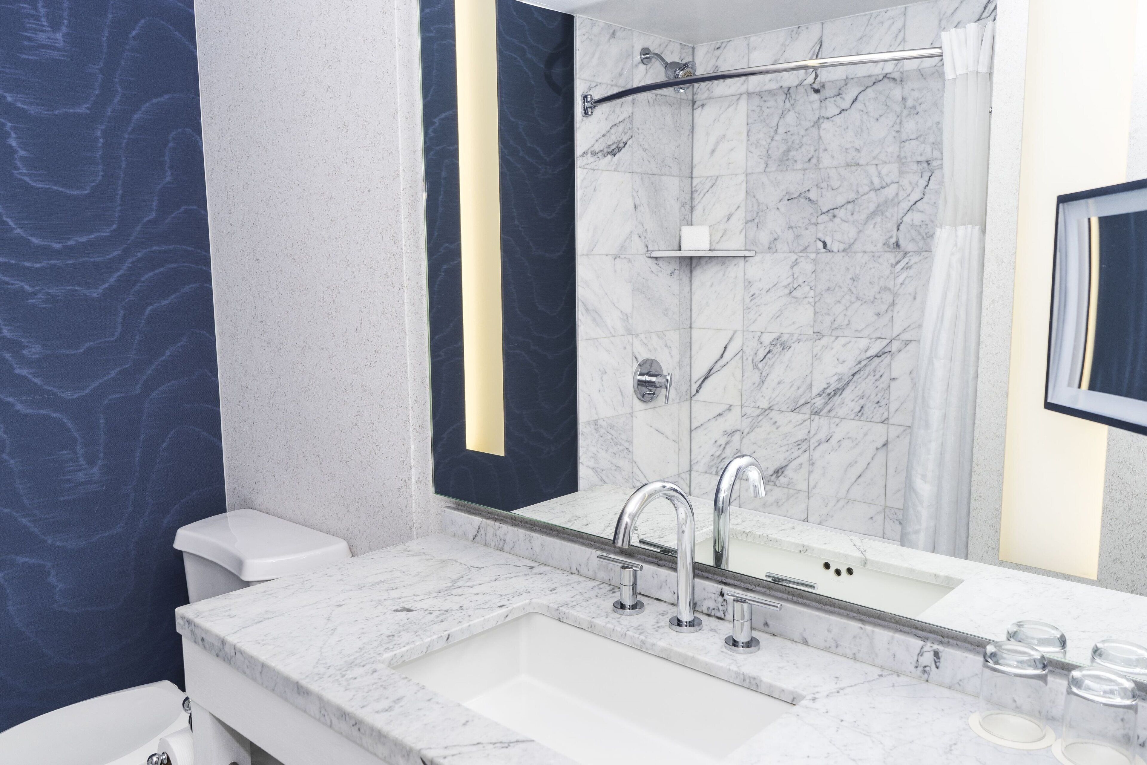 combined shower/bathtub, designer toiletries, hair dryer, bathrobes