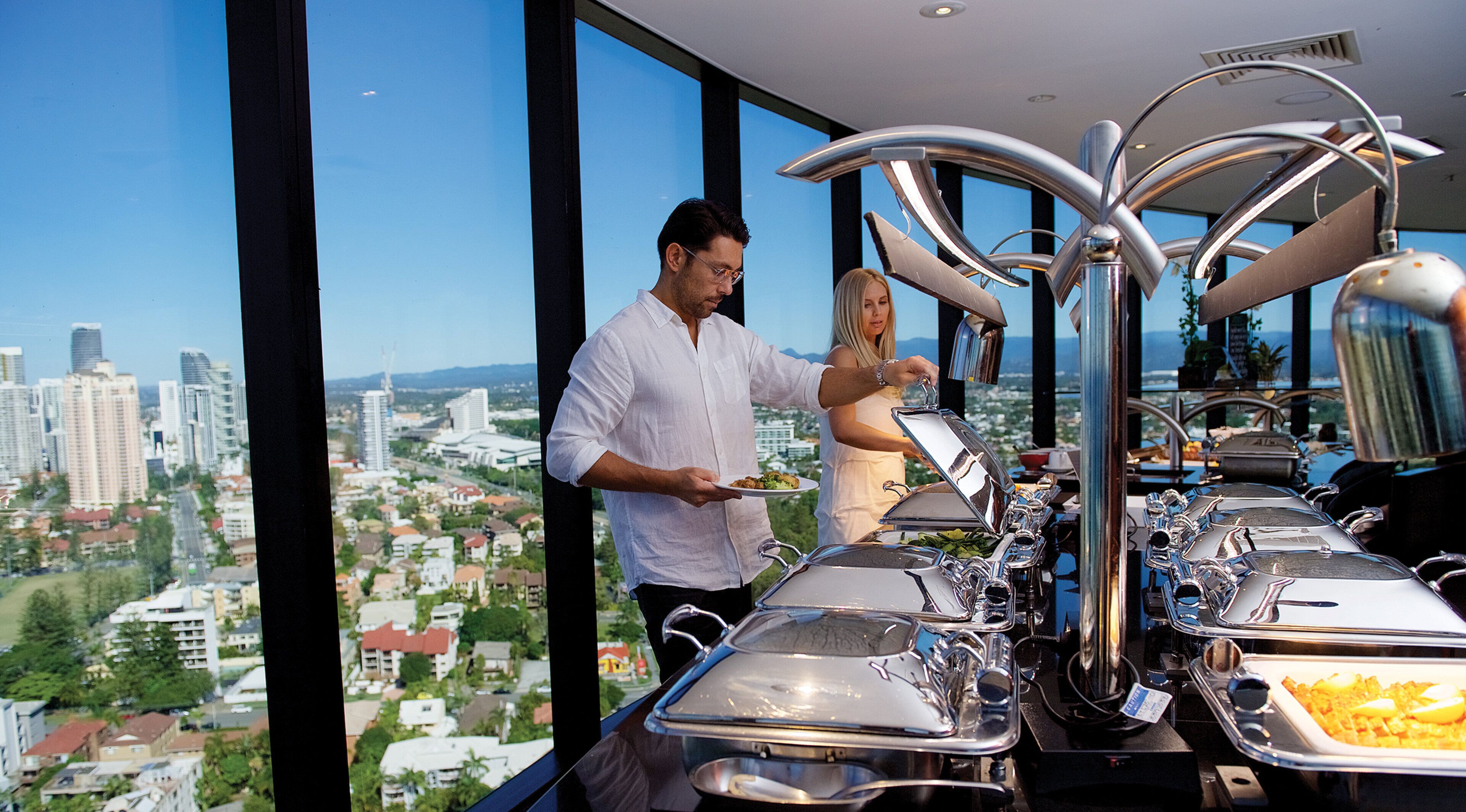 Un buffet avec plusieurs points de service et une vue sur la ville en arrière-plan.