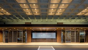 The exterior of ANA CROWNE PLAZA with a modern glass facade and a large illuminated sign. - ANA Crowne Plaza Sapporo by IHG (Sapporo)