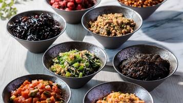 A variety of dishes in bowls on a table.