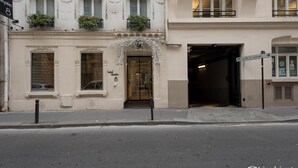 A hotel entrance with a classic facade, a glass door, and a sign indicating 'Gare St Lazare'. - Hotel Elysees 8 (Paris)