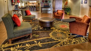 A lobby with seating, a bar area, and a dining space.