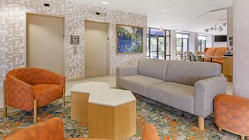 A modern interior with a sofa, chairs, and a coffee table.