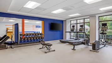 A gym with weightlifting equipment, treadmills, and exercise machines.