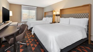 A hotel room with two beds, a desk with a computer, and a chair. - Holiday Inn Westbury - Long Island by IHG (Carle Place)