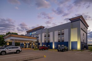 A hotel with a 'Best Western' sign, a gas station, and a security vehicle.