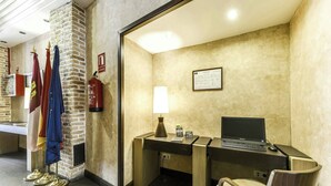 A hotel room with a desk, chair, lamp, and a fire extinguisher. - Hotel Sercotel Alfonso VI (Toledo)