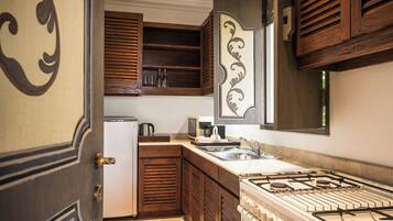 A kitchen with wooden cabinets, a stove, and a sink.
