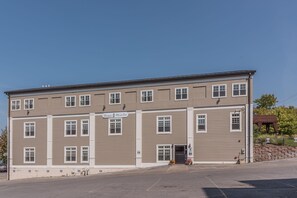 A two-story building with a sign reading "Harbor House Inn".
