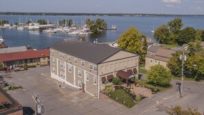 A building with a flat roof and a parking lot in front.