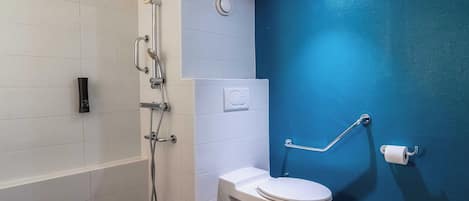 A bathroom with a bathtub, a toilet, and a shower.