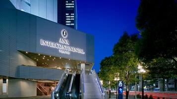 The exterior of ANA Intercontinental Tokyo with a modern design, featuring a prominent entrance and escalators leading to the lobby.