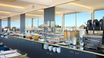A breakfast buffet with various food items and a coffee machine.