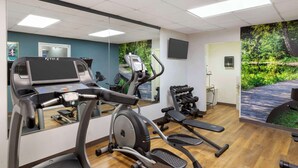 A gym with exercise equipment, a treadmill, and a mirrored wall. - Clarion Pointe Durham Research Triangle Park (Durham)