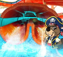 A water ride with a pirate-themed character and a large water wheel structure.
