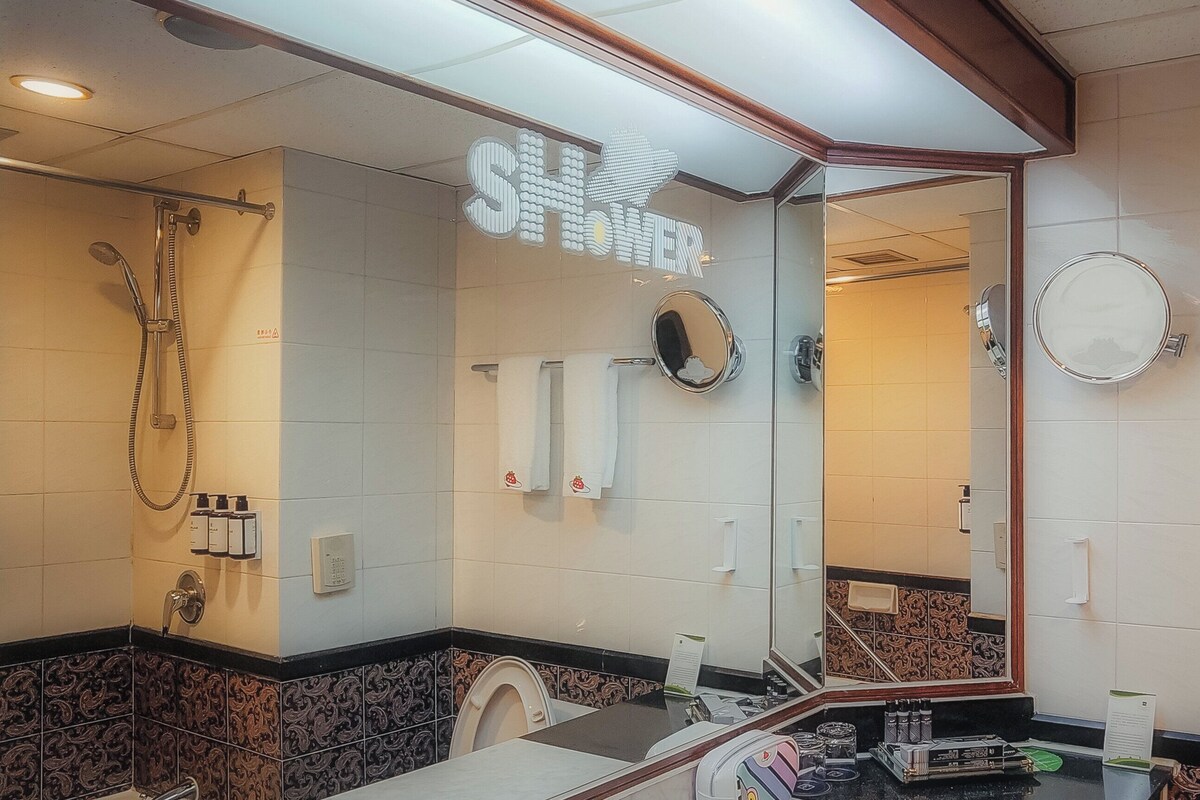 A modern bathroom with a shower, toilet, and vanity.