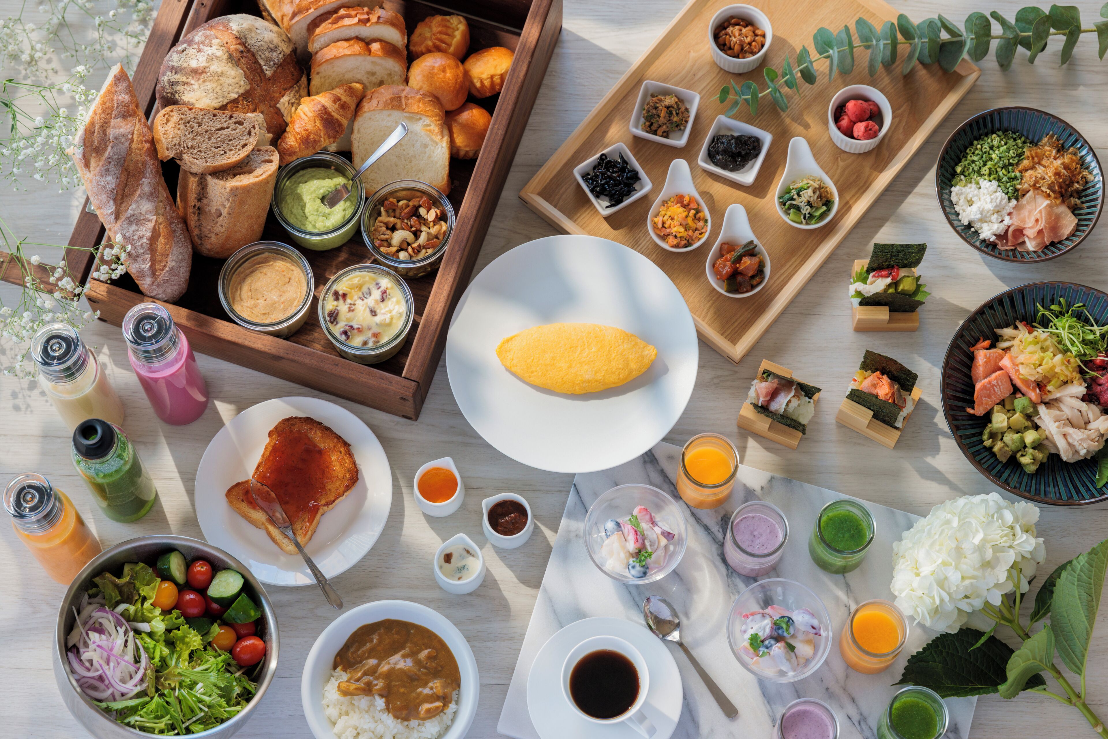 A variety of food items and beverages arranged on a table.