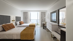 A hotel room with two beds, a large mirror, a TV, and a balcony with curtains. - Cirque St. Armands Beachside (Sarasota)