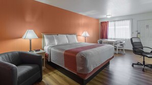A hotel room with a bed, two bedside lamps, a desk, a chair, and a window with curtains. - Motel 6 Lordsburg, NM (Lordsburg)