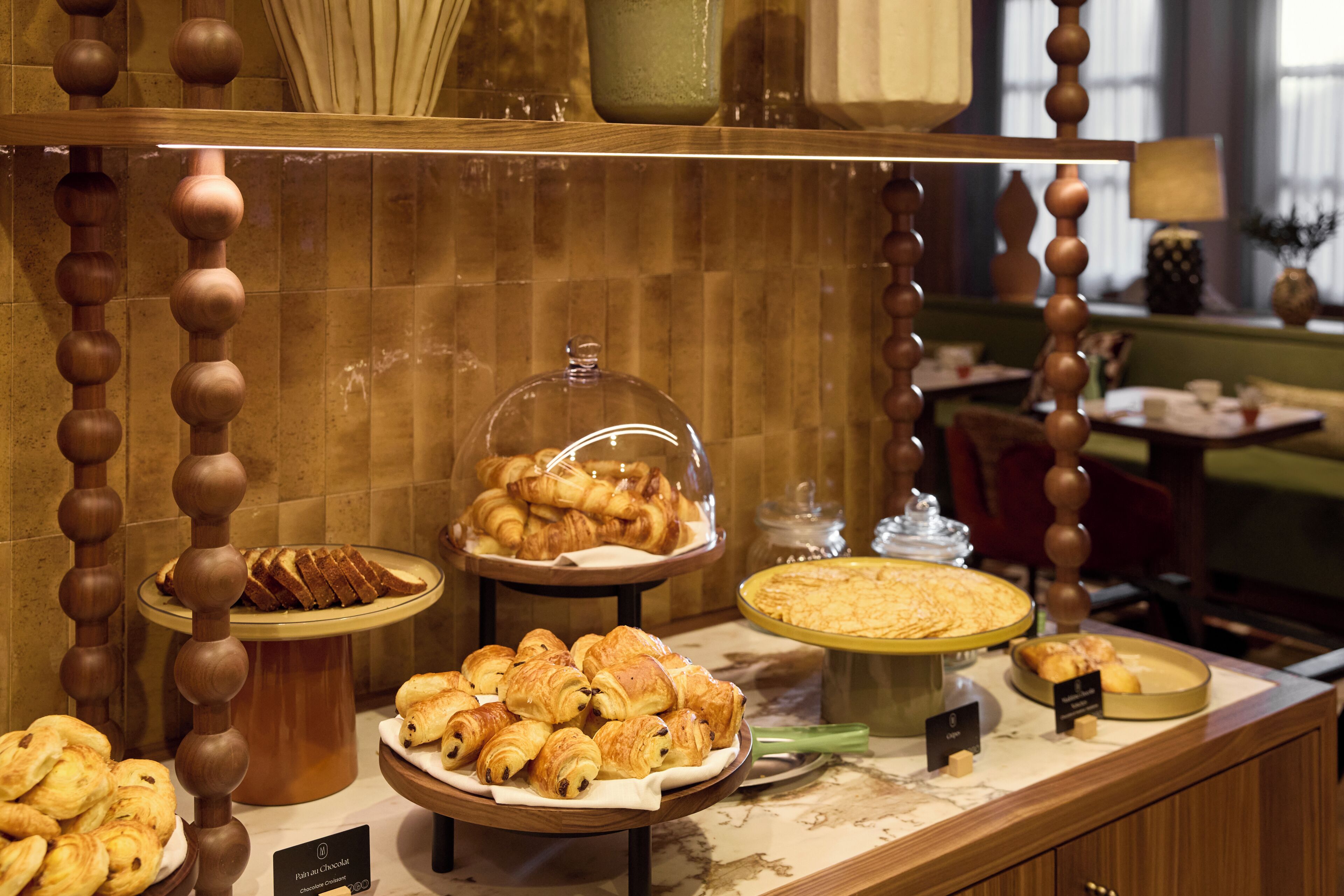 A buffet with various pastries and a glass display case.