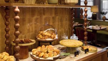 A buffet with various pastries and a glass display case.
