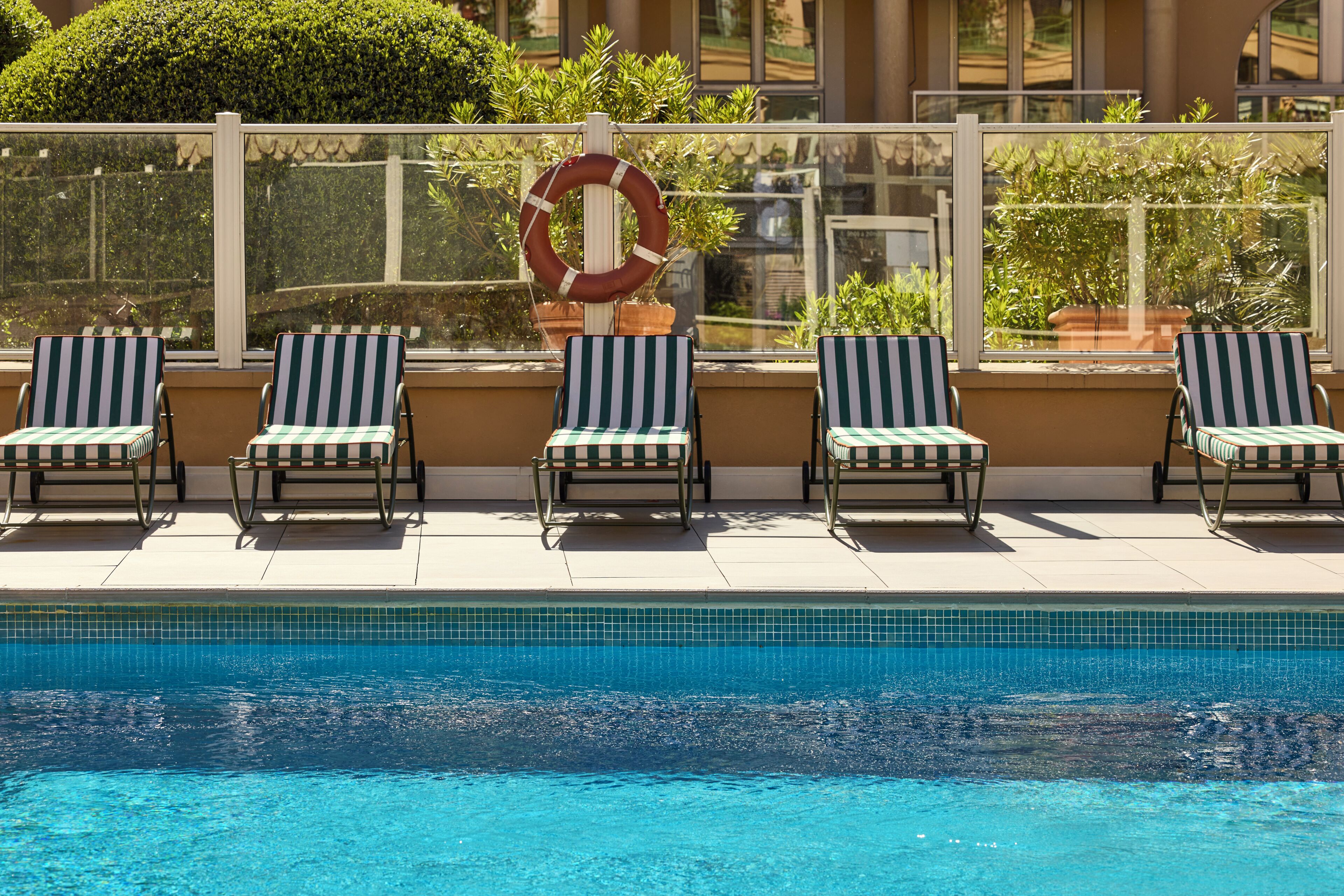Seasonal outdoor pool, open 9:00 AM to 8:00 PM, pool umbrellas