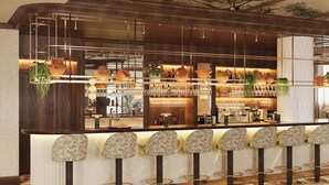 A bar area with a wooden counter, multiple bar stools, and a variety of bar tools and bottles. - Grand Hôtel Roi René Aix - MGallery Collection (Aix-en-Provence)