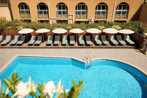 Seasonal outdoor pool, open 9:00 AM to 8:00 PM, pool umbrellas