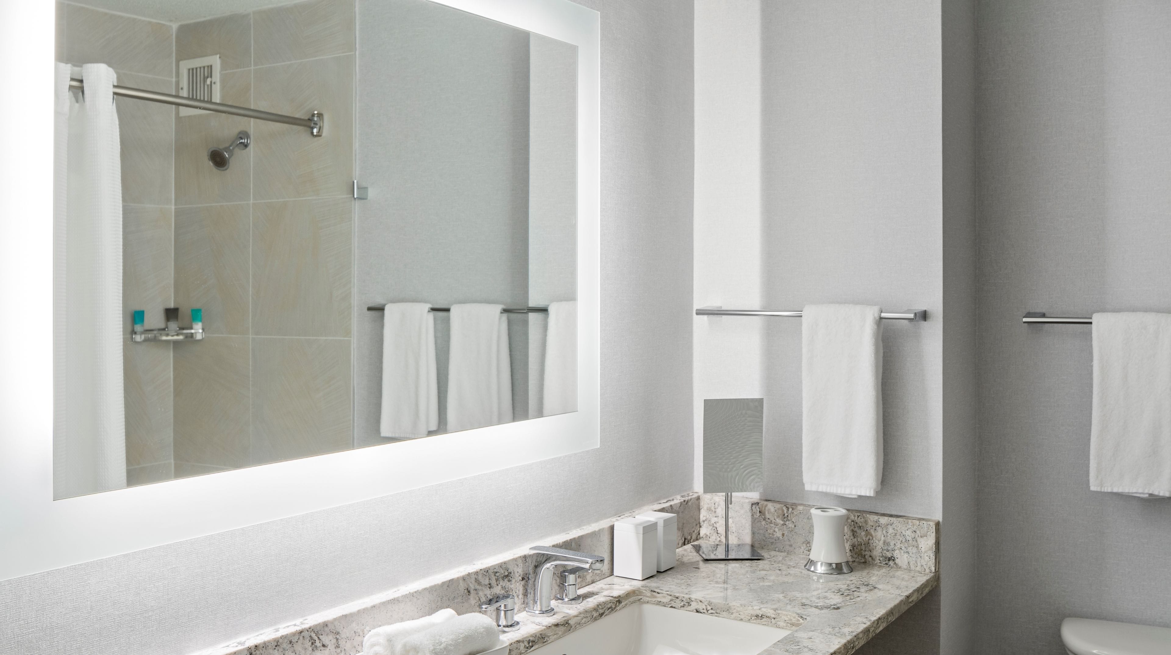 designer toiletries, hair dryer, towels, soap