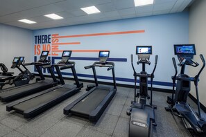 A gym with treadmills and elliptical machines, motivational wall art, and digital screens. - Hampton Inn & Suites Asheville Biltmore Village (Asheville)