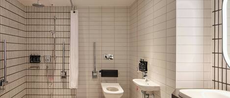 A modern bathroom with a shower, toilet, and sink.