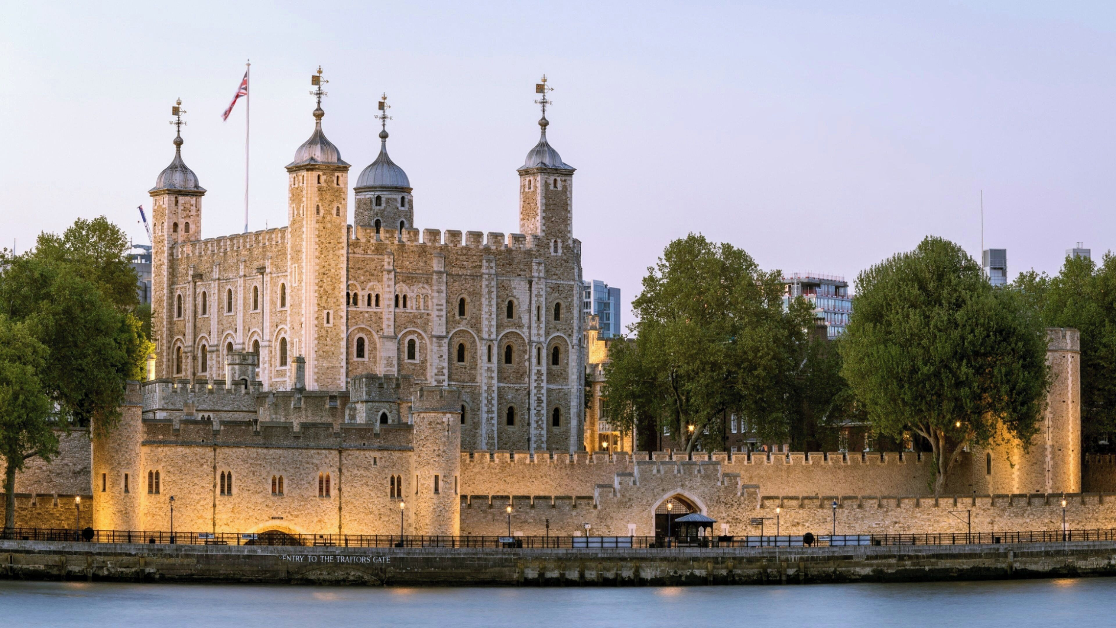 A historic stone castle with multiple towers and a fortified entrance gate.