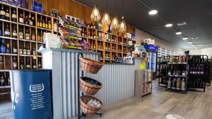 A liquor store with shelves stocked with various bottles and a refrigerated display.