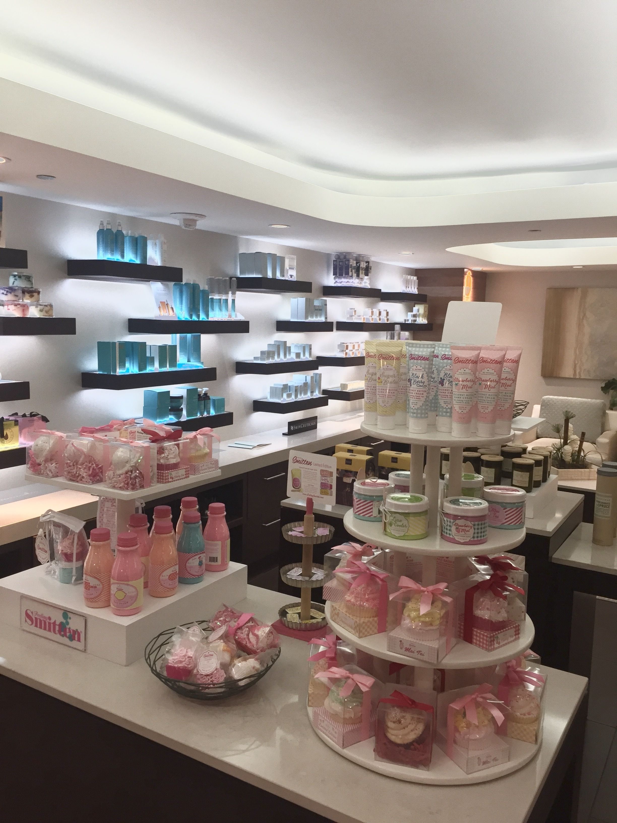 A well-lit retail space with shelves stocked with various products, including bottles and packaged goods.