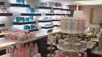 A well-lit retail space with shelves stocked with various products, including bottles and packaged goods.