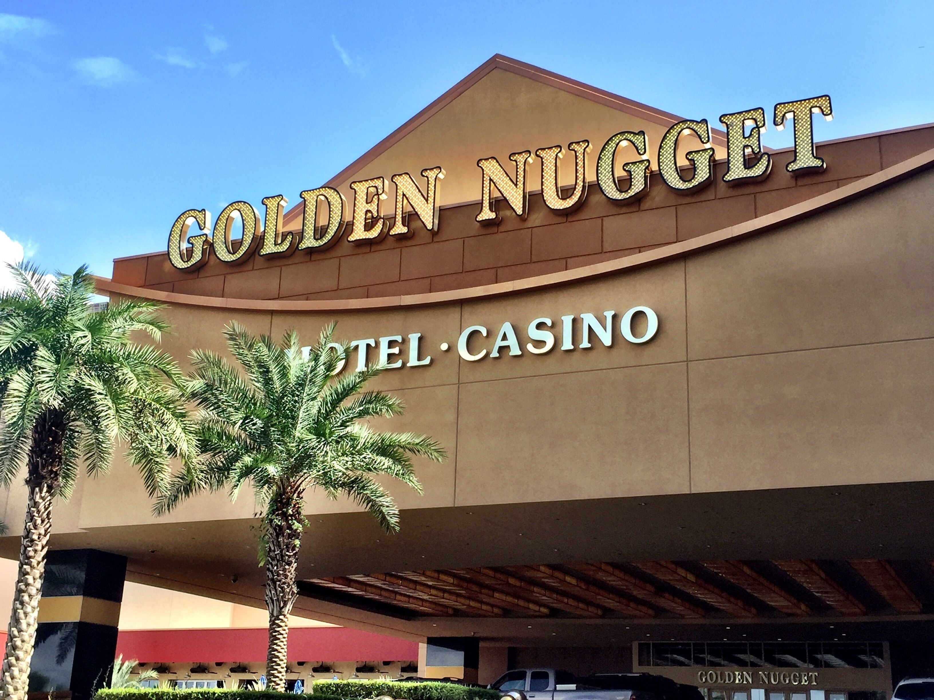 The exterior of the Golden Nugget Hotel & Casino with palm trees in the foreground.