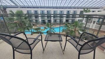 Enjoy a refreshing view of the pool from this balcony.