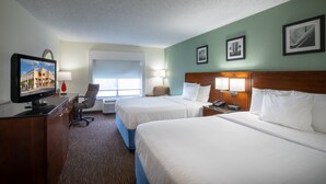 A hotel room with two beds, a desk with a computer, a chair, and a window. - Days Inn by Wyndham Greenville (Greenville)