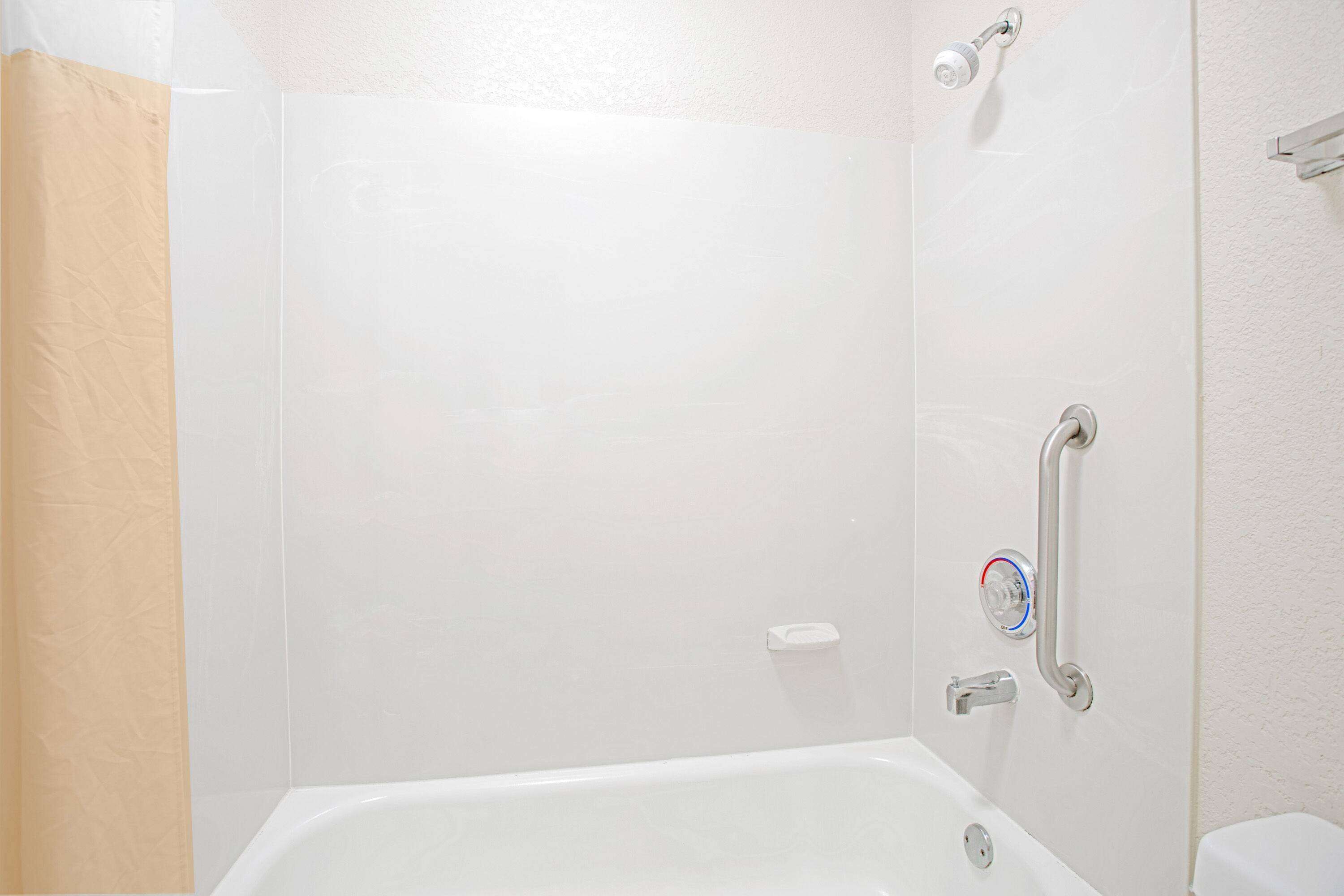 A bathroom with a bathtub, a shower, and a toilet.