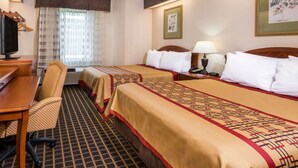 A hotel room with two beds, a desk, a chair, a television, and a window with curtains. - Days Inn by Wyndham Yadkinville (Yadkinville)