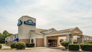 A Days Inn hotel with a prominent sign, a covered entrance, and well-maintained landscaping. - Days Inn by Wyndham Yadkinville (Yadkinville)